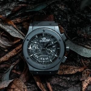 Elegant Hublot watch elegantly placed on rustic autumn leaves, showcasing intricate design and luxury.